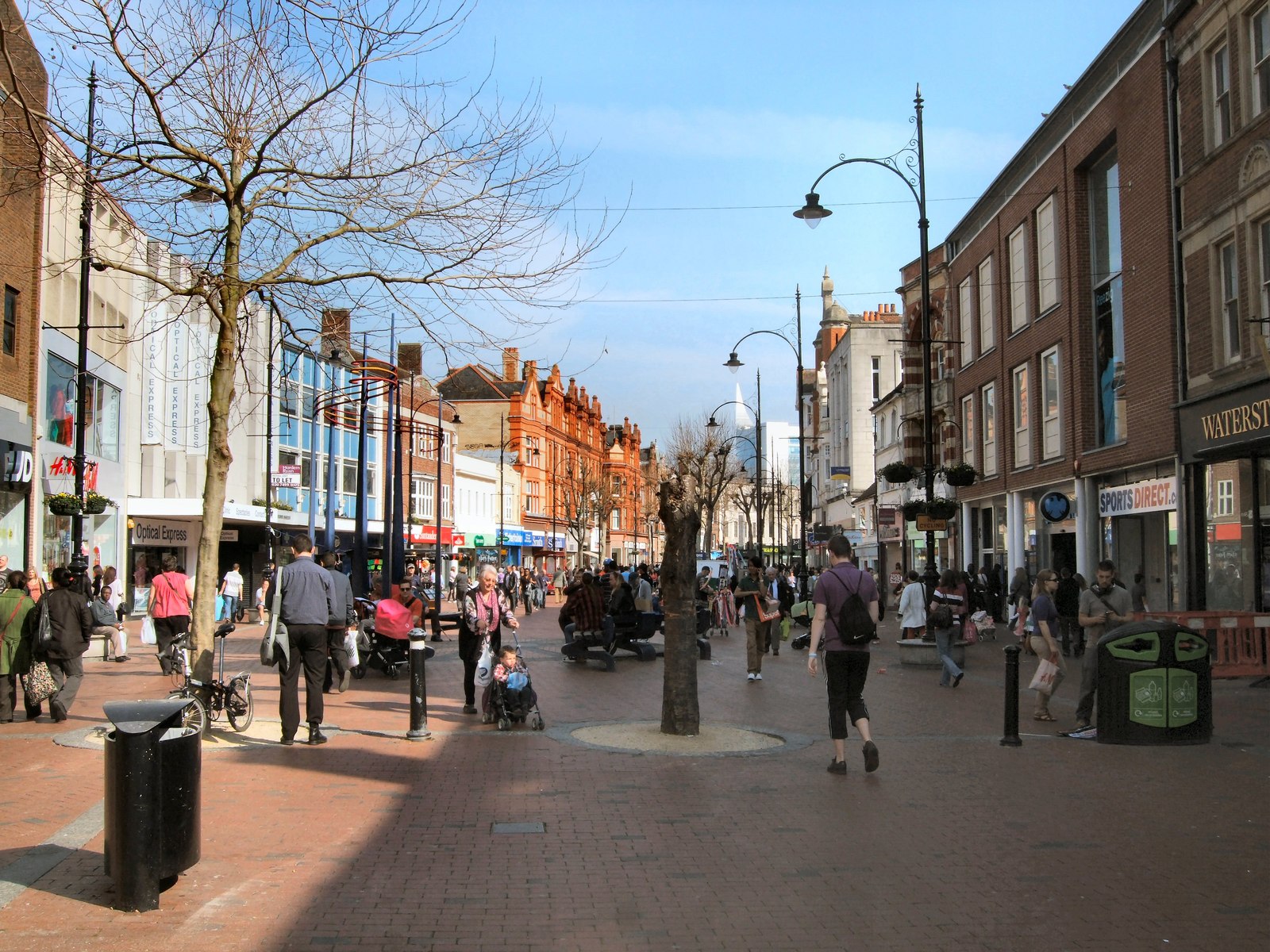Busy Street Scene | How Good Is Life A busy pedestrian street scene shows shops and people walking, reflecting a sense of community.